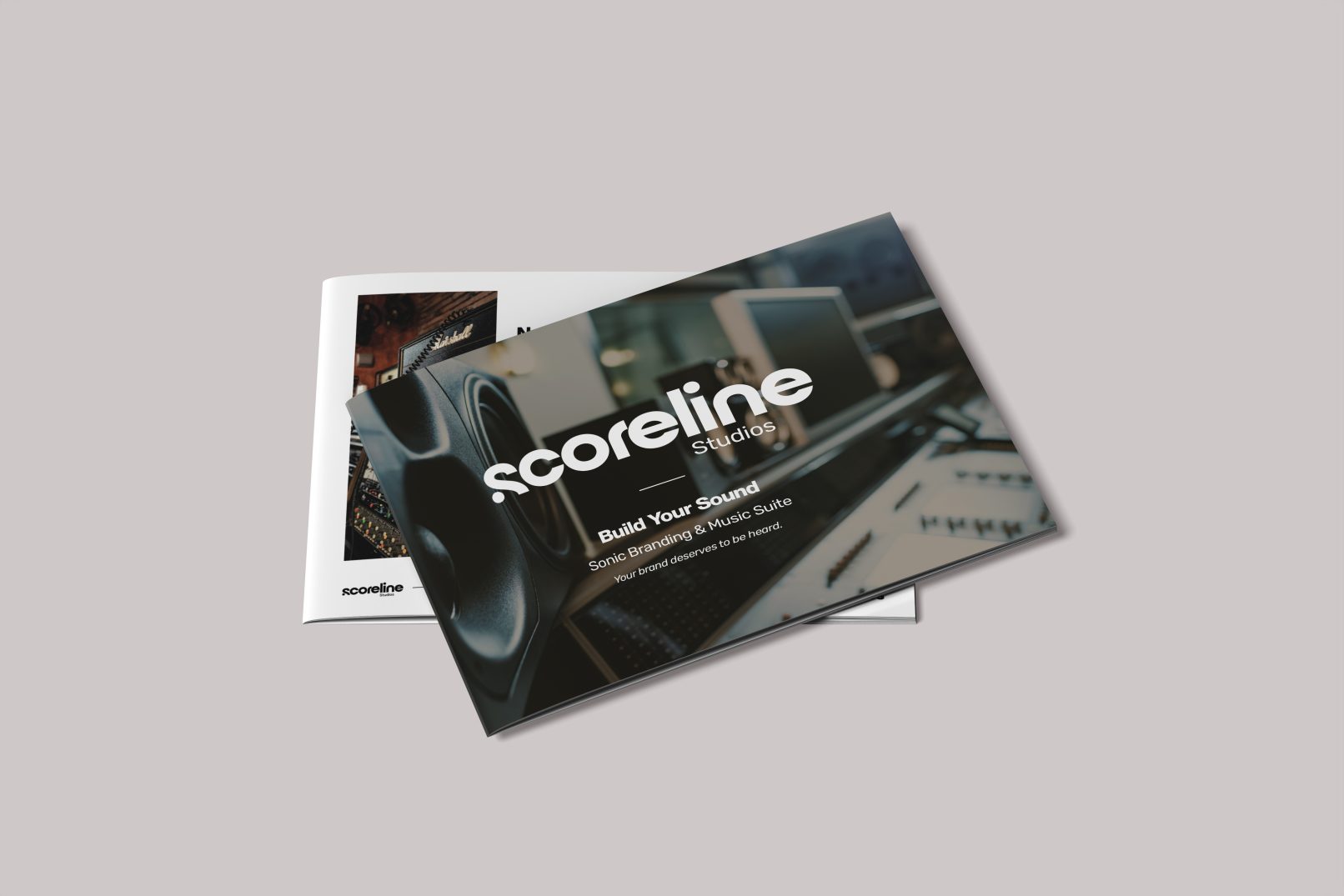 Scoreline Studios brand brochure with a glossy, dark montage of audio equipment and bold white Scoreline logo, conveying a modern branding aesthetic.