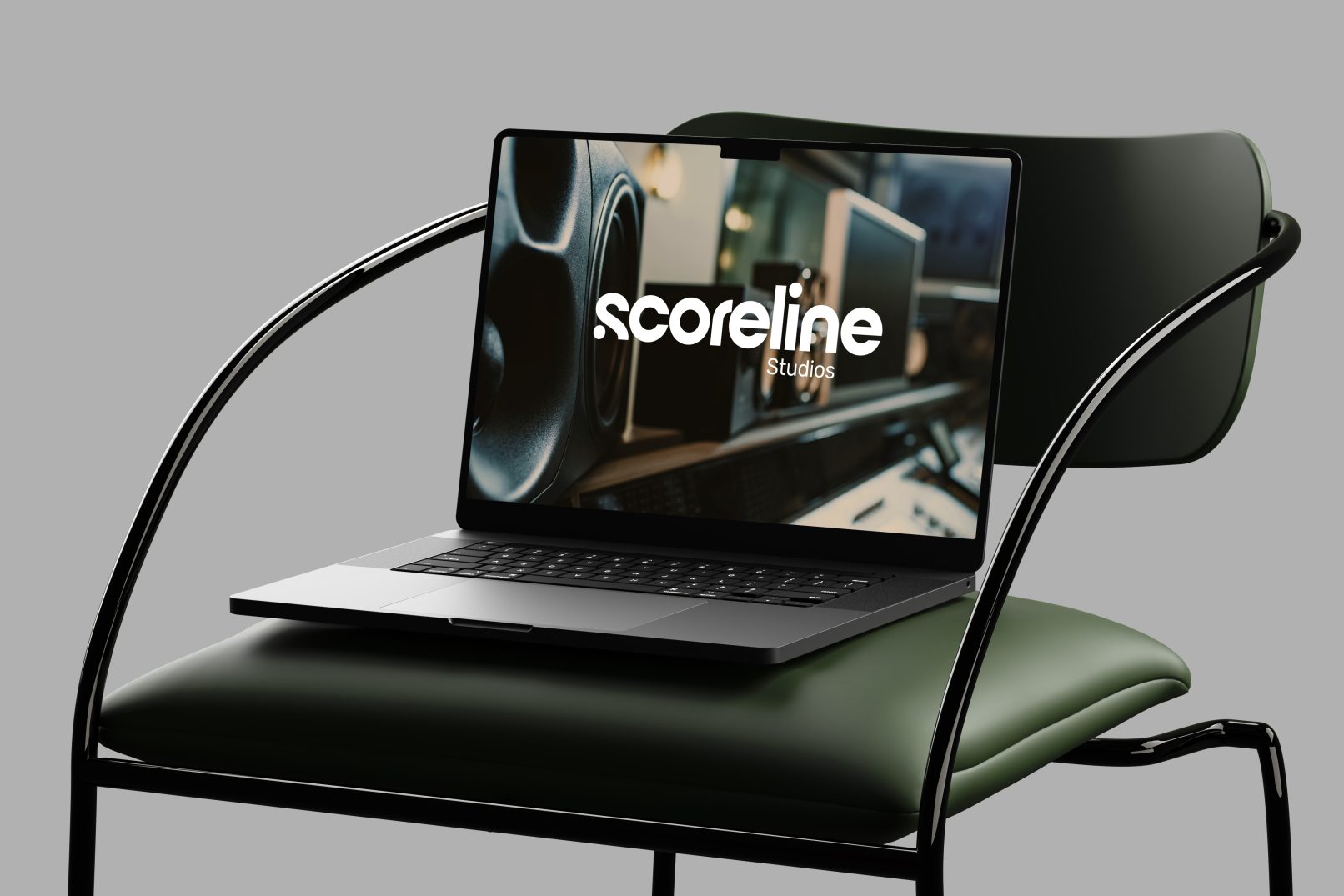 Scoreline Studios branding shown on a laptop screen resting on a sleek chair with a black frame and green cushion; cinematic, modern visuals featuring the Scoreline Studios identity.